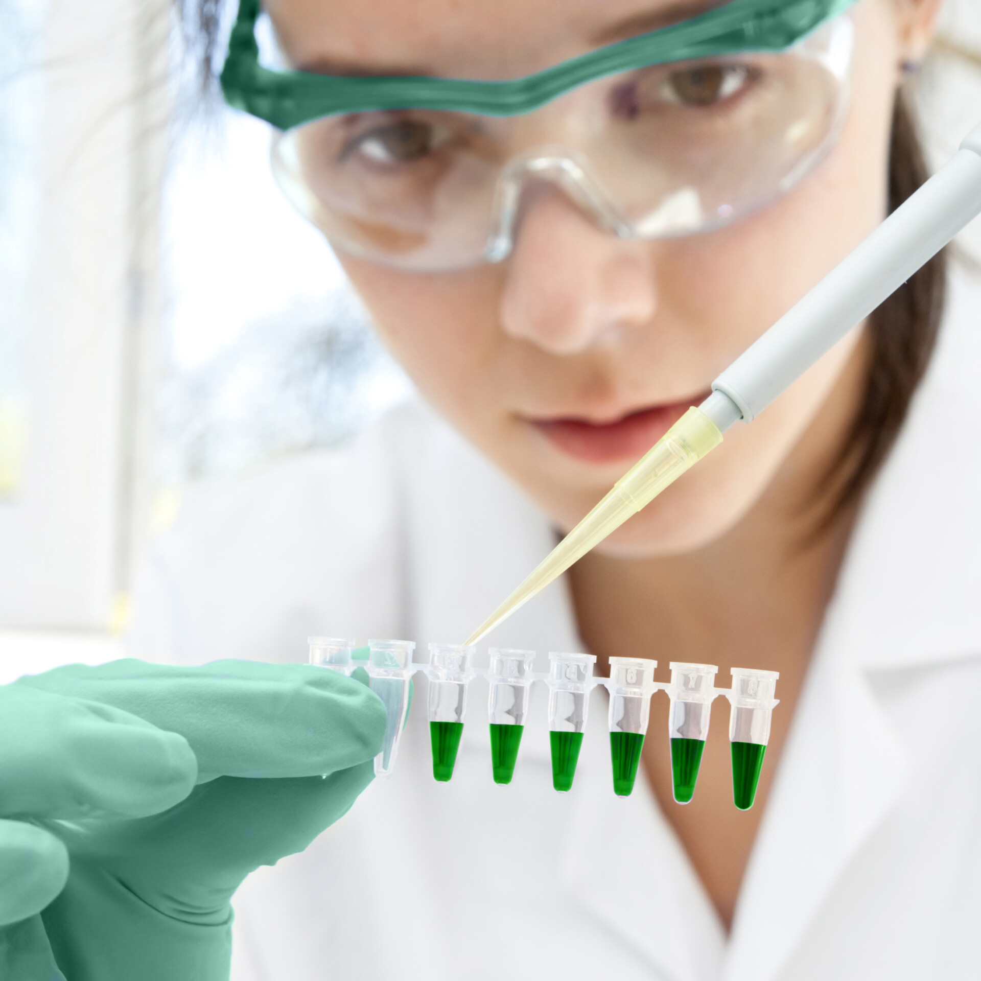 Young female scientist loads samples in R&D